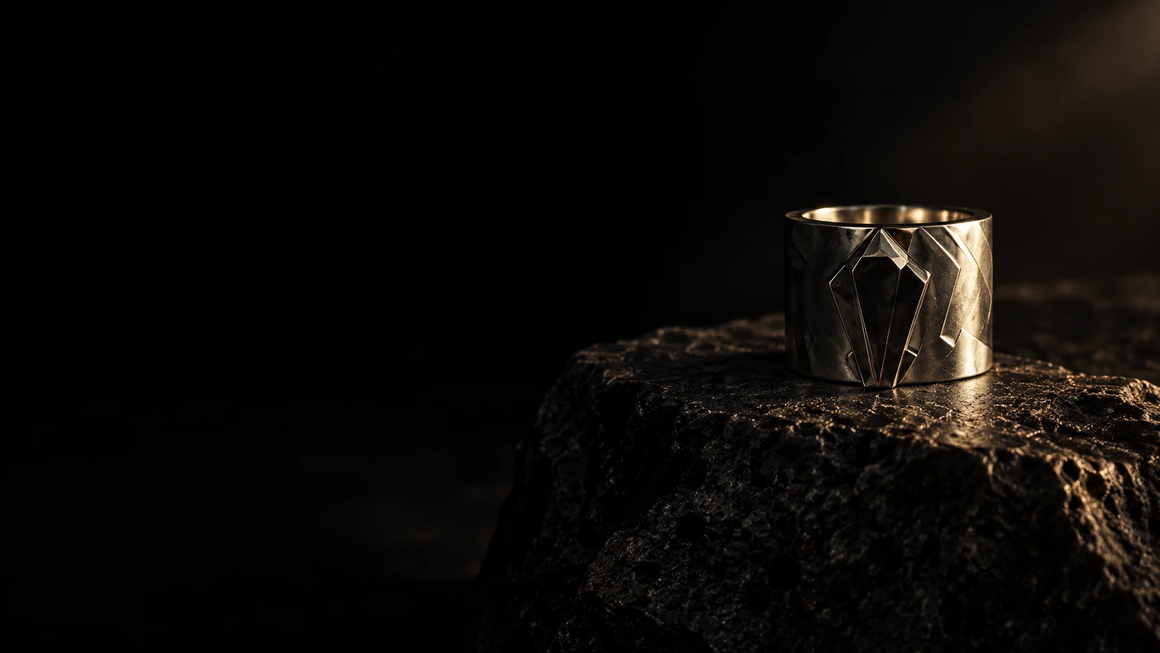 Sculptural silver jewelry in a landscape of shadow and volcanic stone